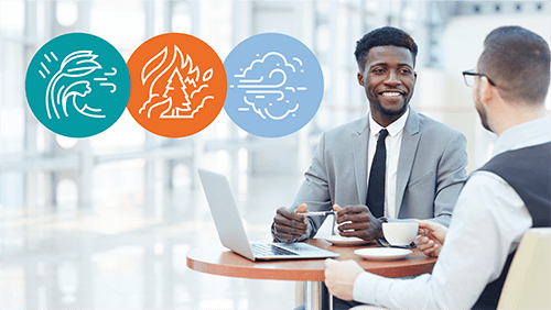 Background Of Two Men Working And Chatting Over Coffee With Icons Representing Hurricanes, Wildfires And Dust Storms Overlaid.