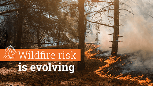Background Image Of A Wildfire With Text That Says: Wildfire Risk Is Evolving.